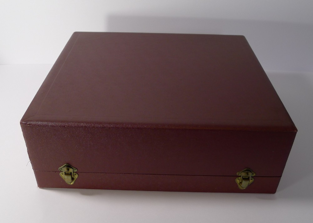 A silver-plated Art Deco cocktail shaker and eight matching cups housed within an open burgundy velvet and cream satin fitted case. View V