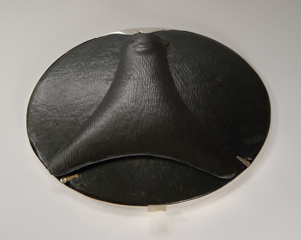 An oval French silver photograph frame featuring engine-turned detail along the rim and a small crown motif at the top centre. View V