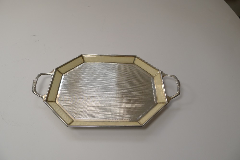 An octagonal sterling silver tray featuring a central engine-turned pattern, a cream guilloche enamel border, and integrated side handles. View III
