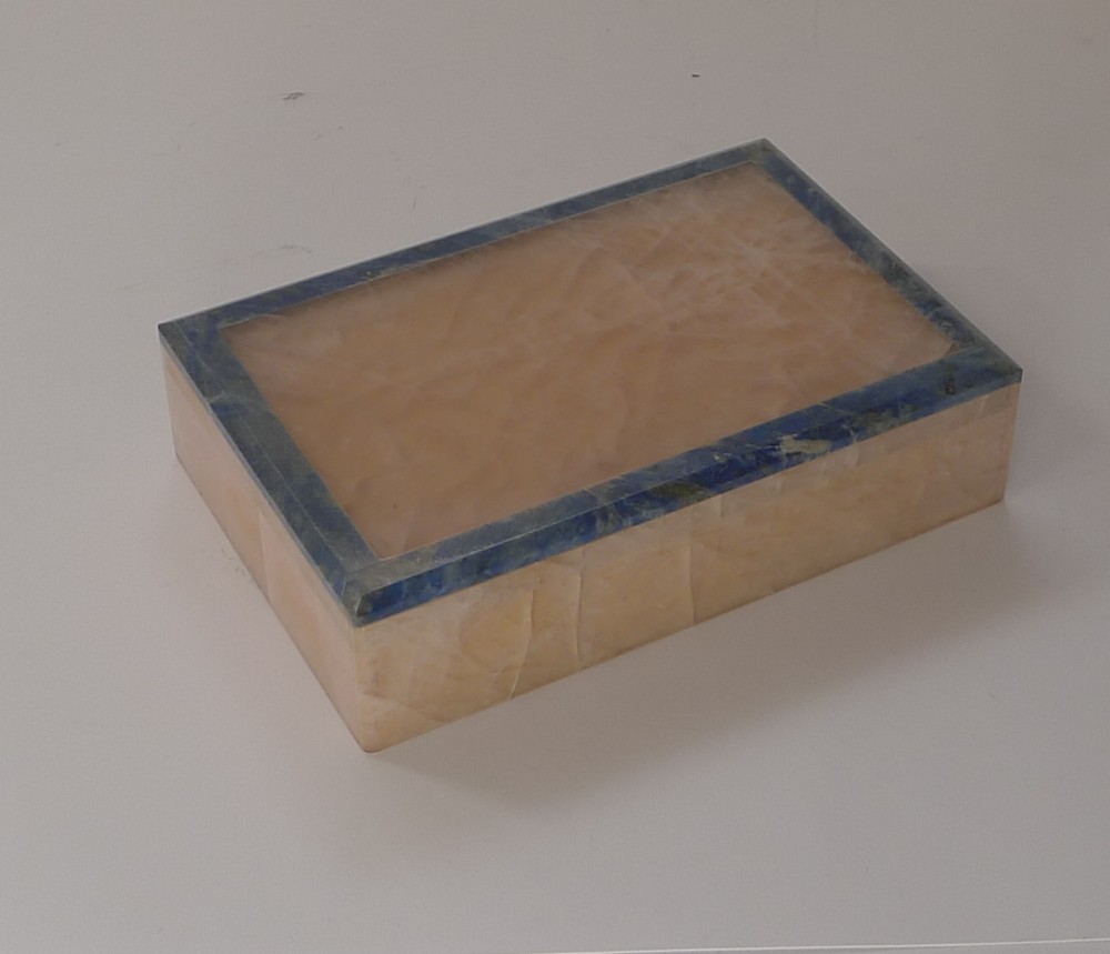 A rectangular rose quartz box featuring a flat lid accented with a deep blue lapis lazuli border.