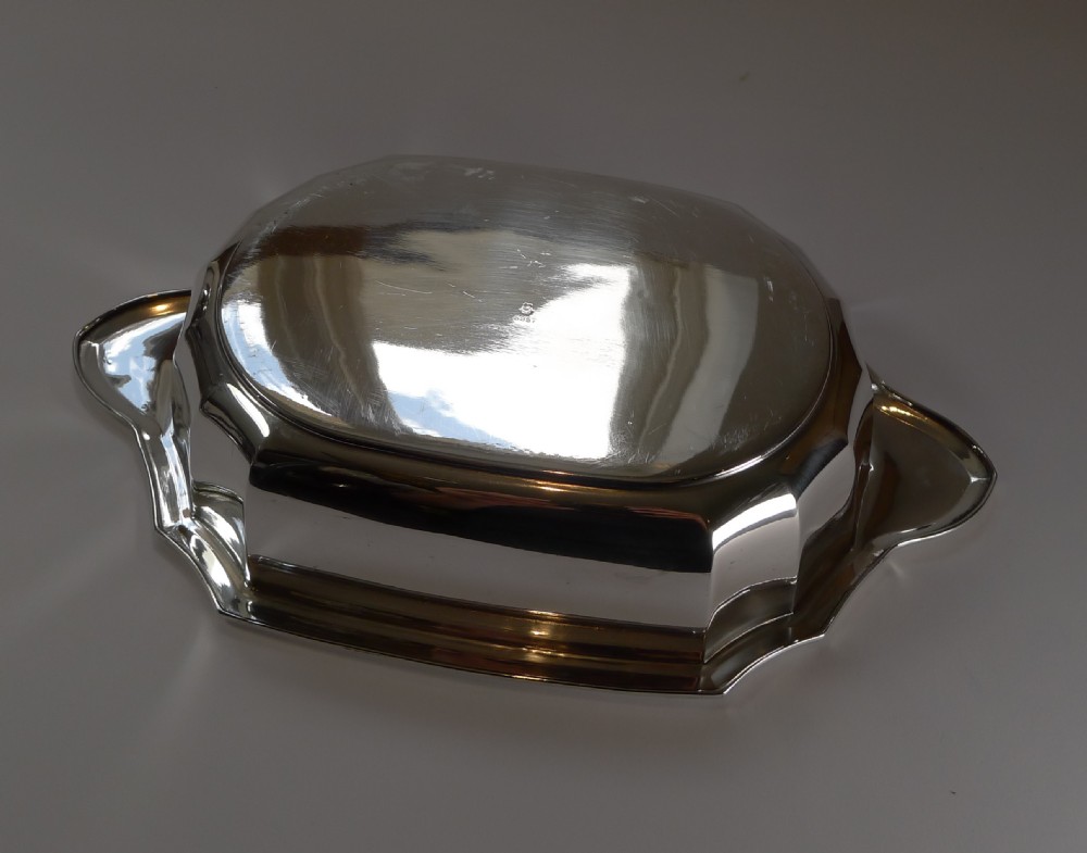 An Art Deco silver-plated covered serving dish featuring a faceted fluted body, matching lid, and a dark wood oval finial. View II