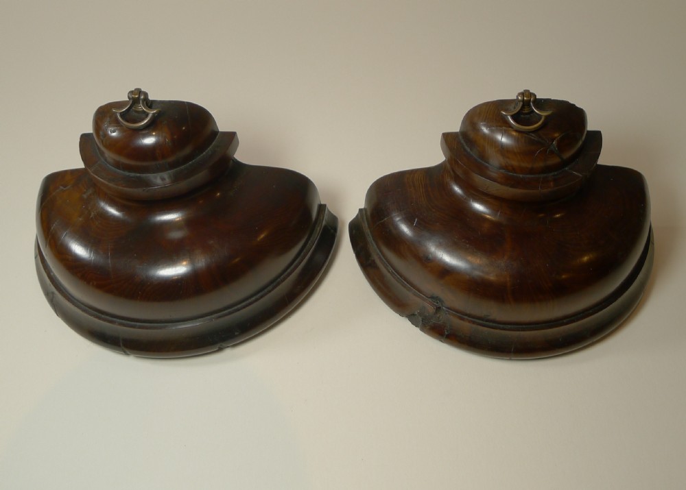 A pair of turned dark yew wood bookends featuring stepped moulded bases, domed tops, and brass ring handles. View IV