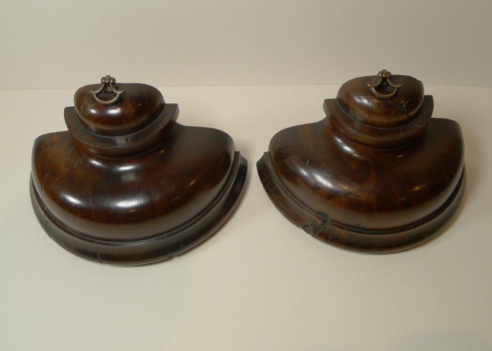 A pair of turned dark yew wood bookends featuring stepped moulded bases, domed tops, and brass ring handles. View VI