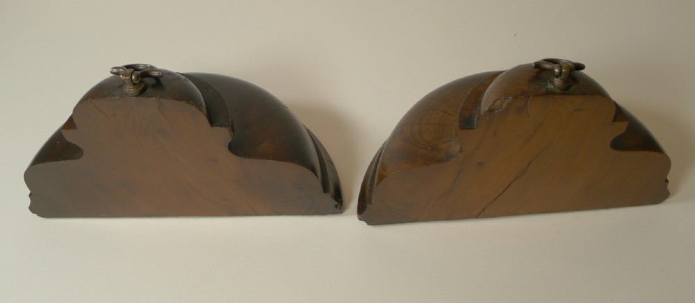 A pair of turned dark yew wood bookends featuring stepped moulded bases, domed tops, and brass ring handles. View VIII