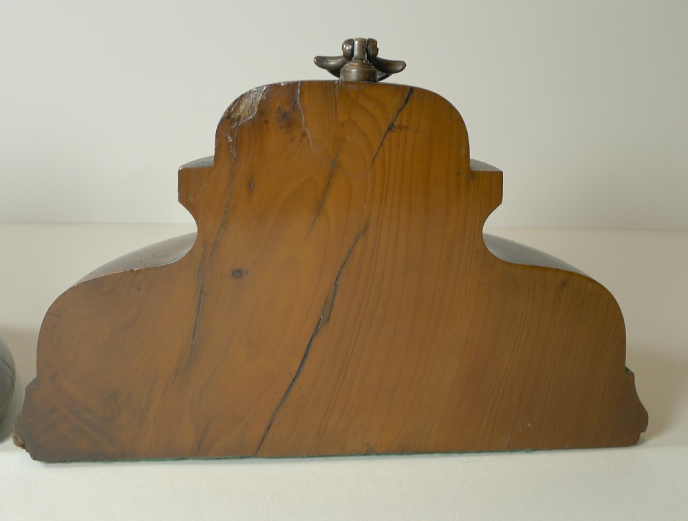A pair of turned dark yew wood bookends featuring stepped moulded bases, domed tops, and brass ring handles. View IX
