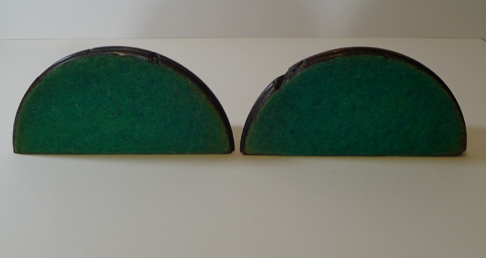 A pair of turned dark yew wood bookends featuring stepped moulded bases, domed tops, and brass ring handles. View XIV