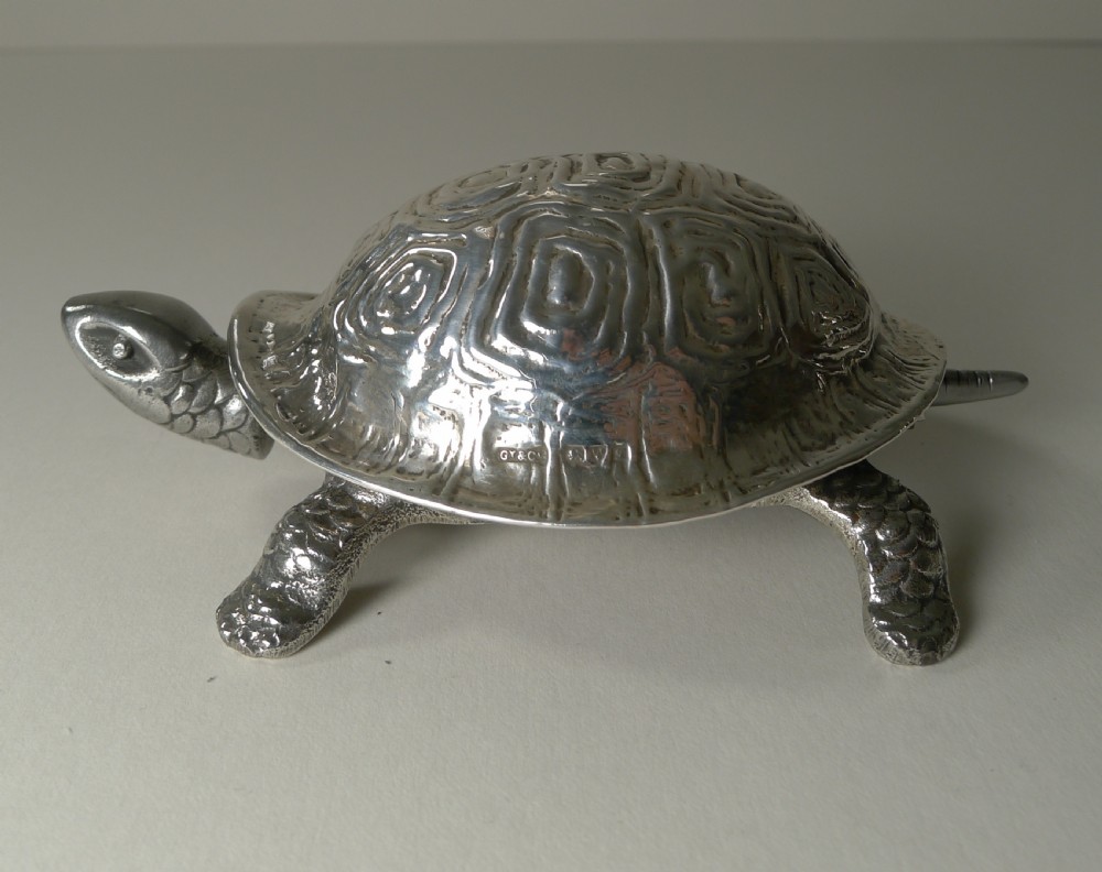 An Edwardian sterling silver novelty desk bell cast in the detailed shape of a tortoise with hallmarked shell.