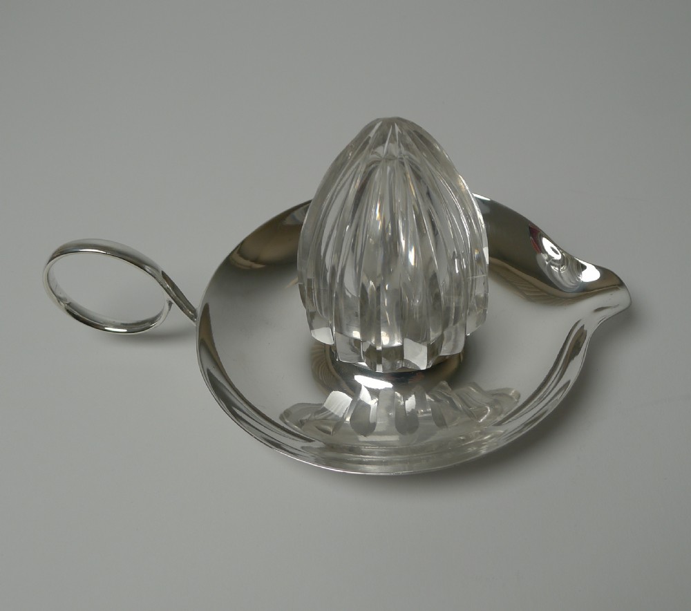 An Edwardian silver plated tray featuring a single loop handle, pouring spout, and a central faceted cut crystal lemon squeezer cone. View VII