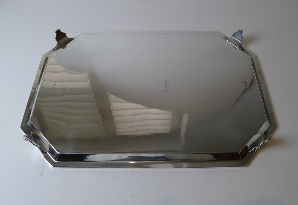 An octagonal silver-plated drinks tray featuring an engraved geometric border, raised rim, and small shell feet. View VIII