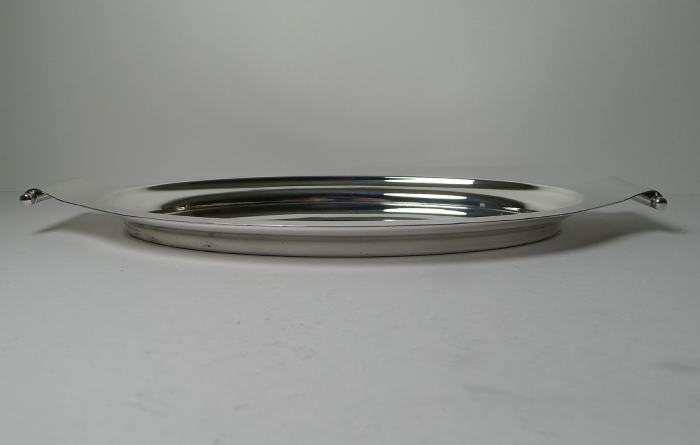 A polished silver-plated oval Art Deco cocktail tray featuring integrated curved handles with spherical accents. View IV