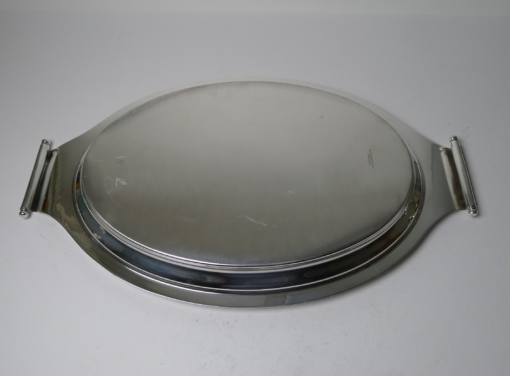 A polished silver-plated oval Art Deco cocktail tray featuring integrated curved handles with spherical accents. View VI