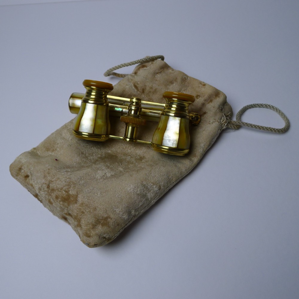 A pair of brass French opera glasses featuring iridescent mother of pearl panels and an extendable side handle. View XI