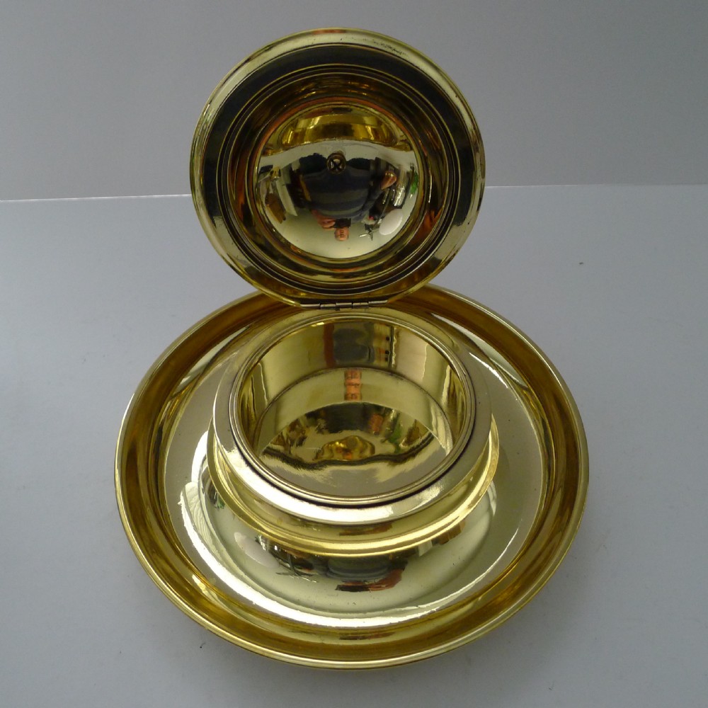 A Victorian novelty inkwell featuring a silvered owl head with yellow glass eyes resting on a circular polished brass dish base. View IV