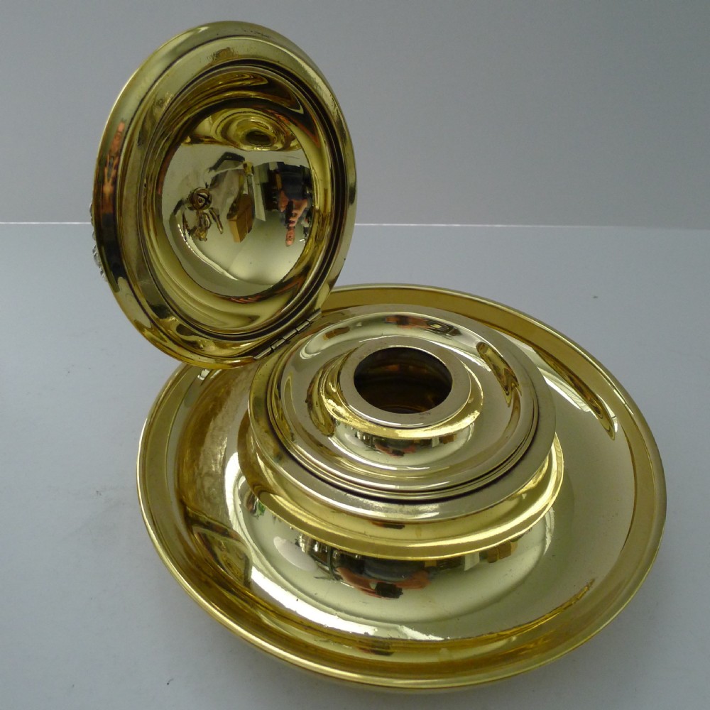 A Victorian novelty inkwell featuring a silvered owl head with yellow glass eyes resting on a circular polished brass dish base. View VI