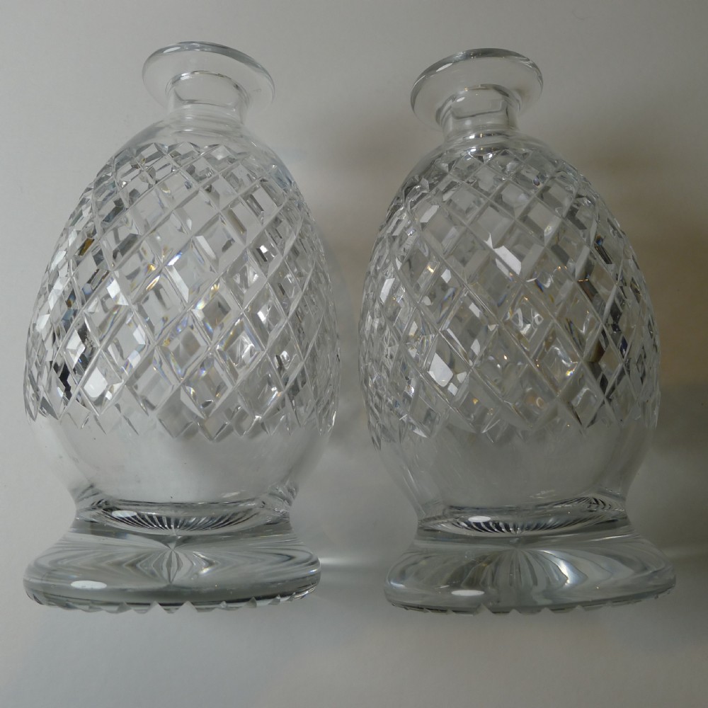 An Edwardian silver-plated double tantalus featuring a central looping frame holding two diamond-pattern cut-glass decanters. View VII