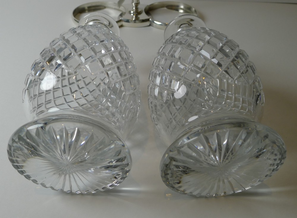 An Edwardian silver-plated double tantalus featuring a central looping frame holding two diamond-pattern cut-glass decanters. View VIII