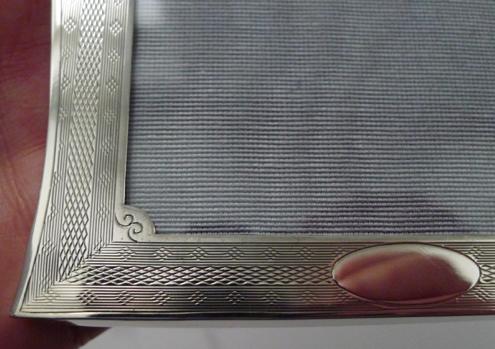 A pair of matching Art Deco silver picture frames with engine-turned geometric engraving and easel backs. View VII