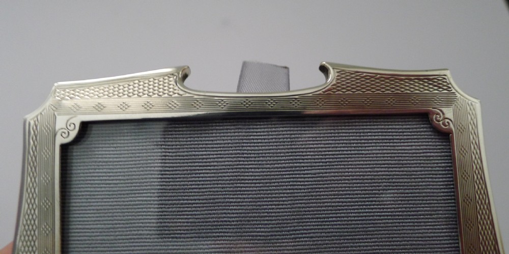 A pair of matching Art Deco silver picture frames with engine-turned geometric engraving and easel backs. View VIII