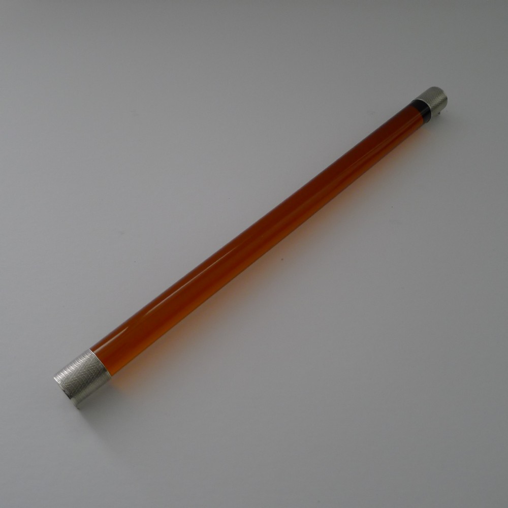 A cylindrical amber glass ruler with textured sterling silver caps fitted to each end.