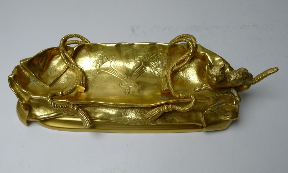 A six-piece gilded bronze desk set decorated with sculpted kitten figures, including two candlesticks, a pen tray, an inkwell, a seal, and a letter opener. View VIII