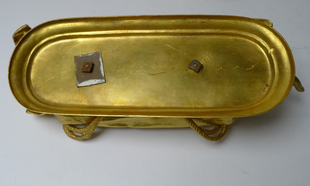 A six-piece gilded bronze desk set decorated with sculpted kitten figures, including two candlesticks, a pen tray, an inkwell, a seal, and a letter opener. View IX
