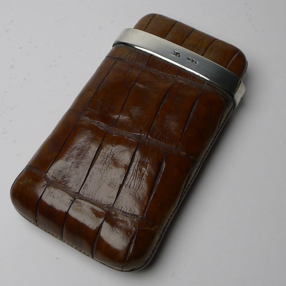 A small Victorian crocodile leather cheroot case in warm brown with a hallmarked silver collar.