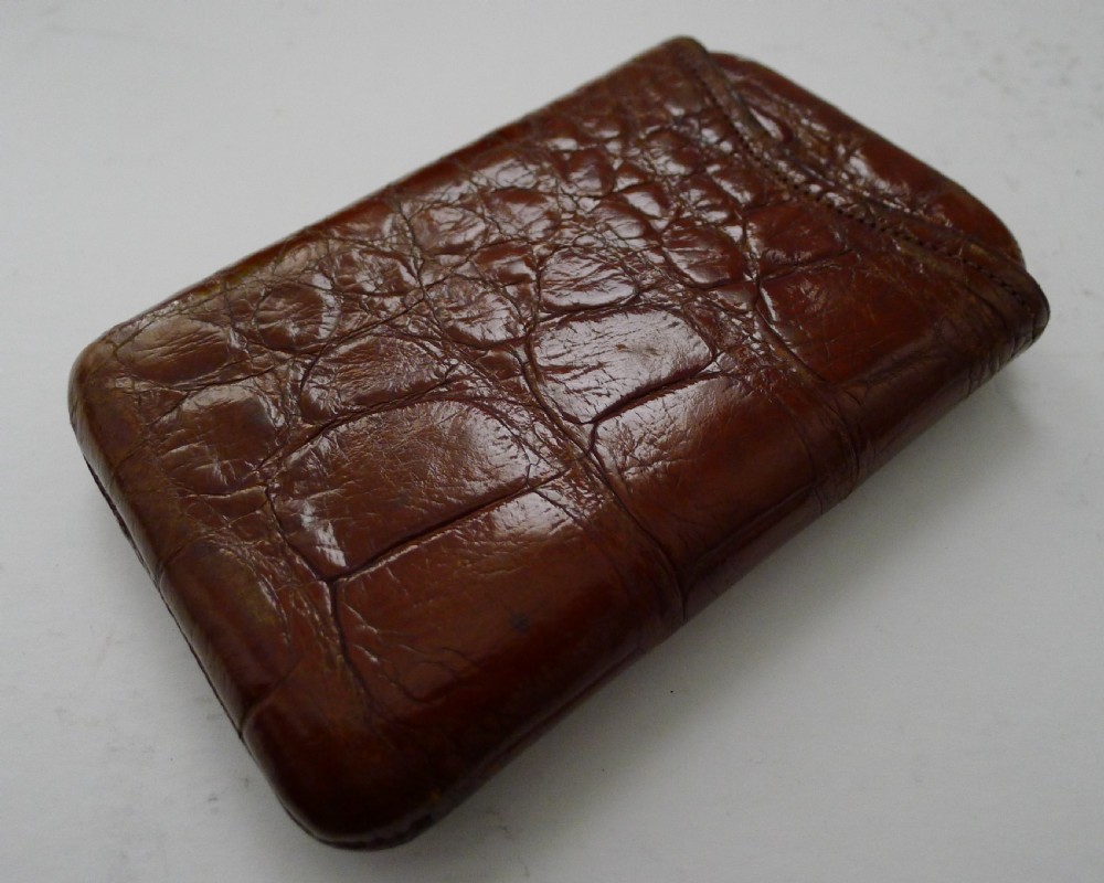 A late Victorian brown crocodile leather pocket cigar case displaying natural scale textures and stitched edges. View III