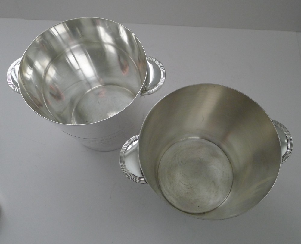 A pair of polished silver-plated Art Deco champagne buckets featuring central horizontal reeded bands and small rectangular side handles. View III