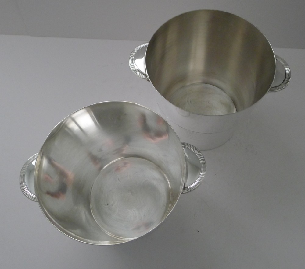 A pair of polished silver-plated Art Deco champagne buckets featuring central horizontal reeded bands and small rectangular side handles. View VIII