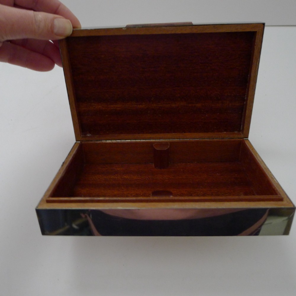 A rectangular silver table box featuring a geometric wire-wrapped border detail and double G emblem on the hinged lid. View XIV
