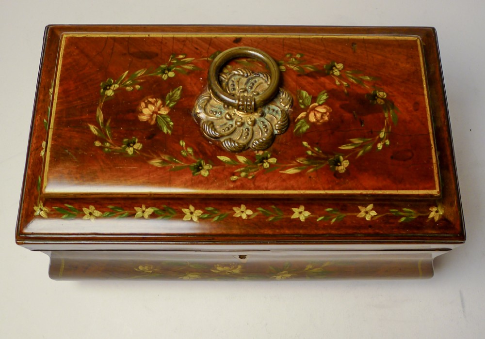A hand-painted Regency mahogany tea caddy featuring floral decoration, a stepped lid, a brass ring handle, and a keyhole escutcheon. View II