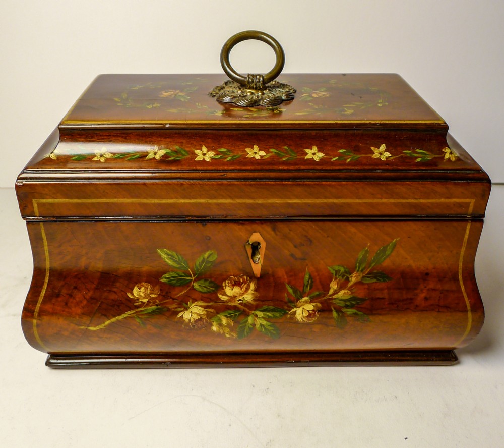 A hand-painted Regency mahogany tea caddy featuring floral decoration, a stepped lid, a brass ring handle, and a keyhole escutcheon. View IX