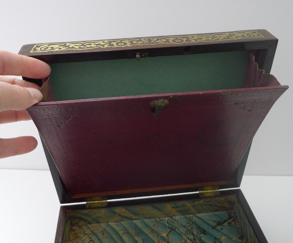 Rectangular dark rosewood jewellery box with elaborate cut-brass floral inlay across the lid and front panel, fitted with a key and tassel. View XI