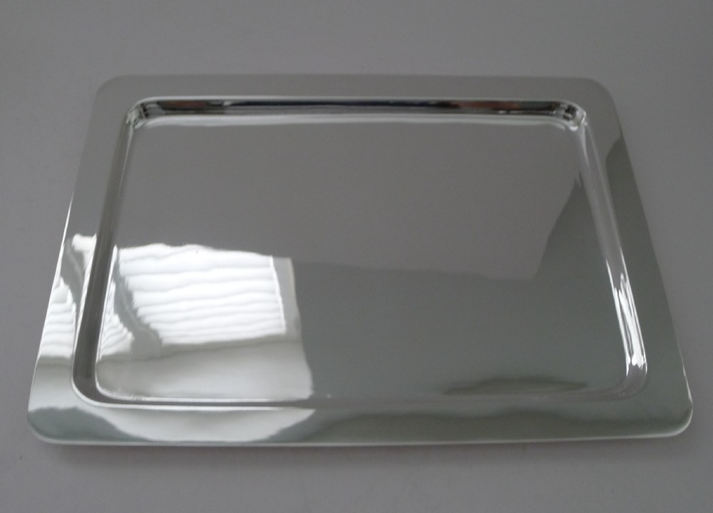 A rectangular polished silver-plated cocktail tray featuring rounded corners and a raised border rim.