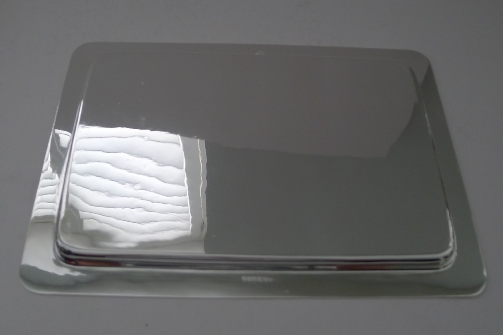 A rectangular polished silver-plated cocktail tray featuring rounded corners and a raised border rim. View VIII