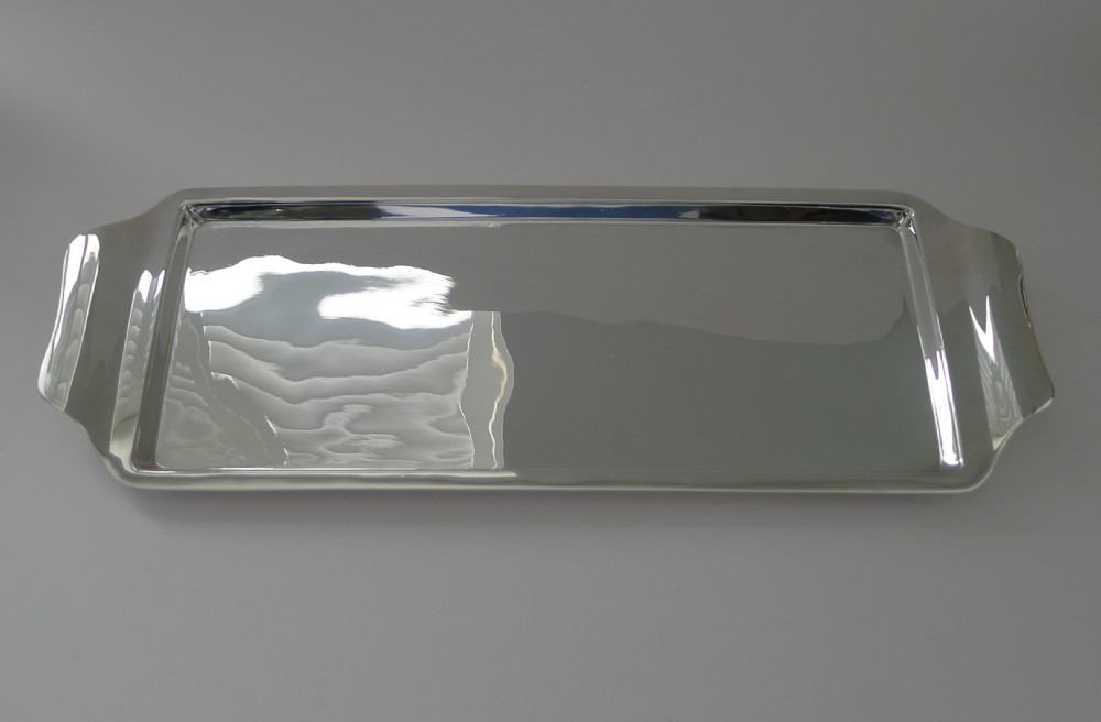 A rectangular Art Deco silver-plated drinks tray featuring integrated curved handles and a smooth polished surface. View IV