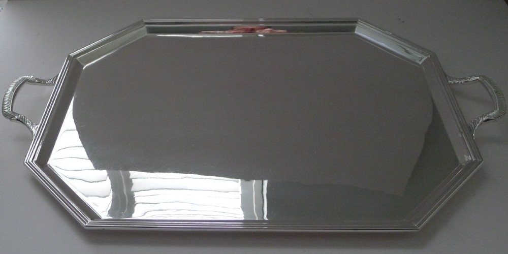 An octagonal Art Deco silver plated drinks tray featuring stepped edge moulding and twin cast handles. View V