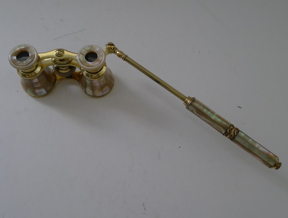 French brass opera glasses featuring mother-of-pearl shell cladding and an extendable side handle on a plain background. View III