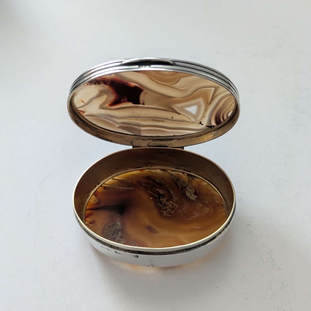 An oval Edwardian sterling silver box featuring polished natural agate stone panels on the hinged top and base. View VII