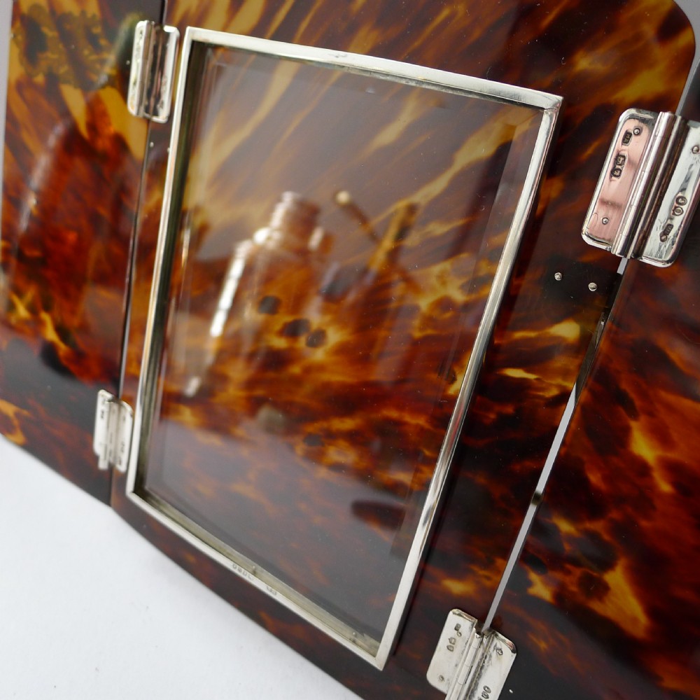 A late 19th-century Victorian tortoiseshell photograph frame featuring arched folding doors, pierced sterling silver mounts, and a silver easel back. View XII