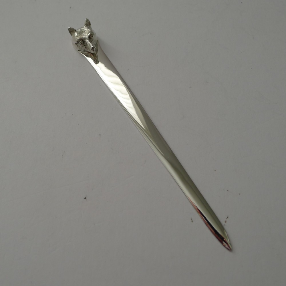 A polished sterling silver letter opener featuring a cast fox head finial atop a smooth tapered blade.