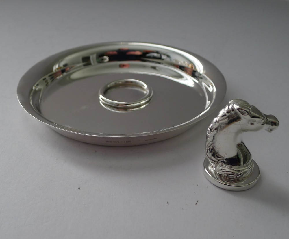 A circular polished silver dish featuring a sculpted equestrian horse head handle at the centre. View V