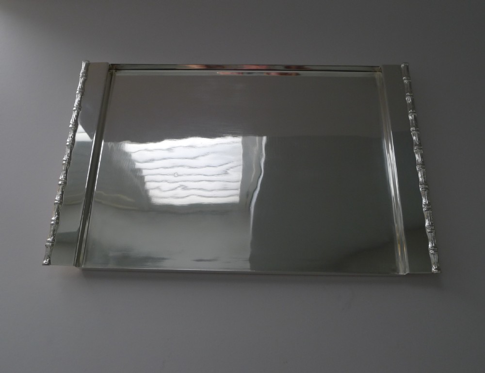 A rectangular polished silver-plated tray featuring cast bamboo-style handles along two opposite ends. View V