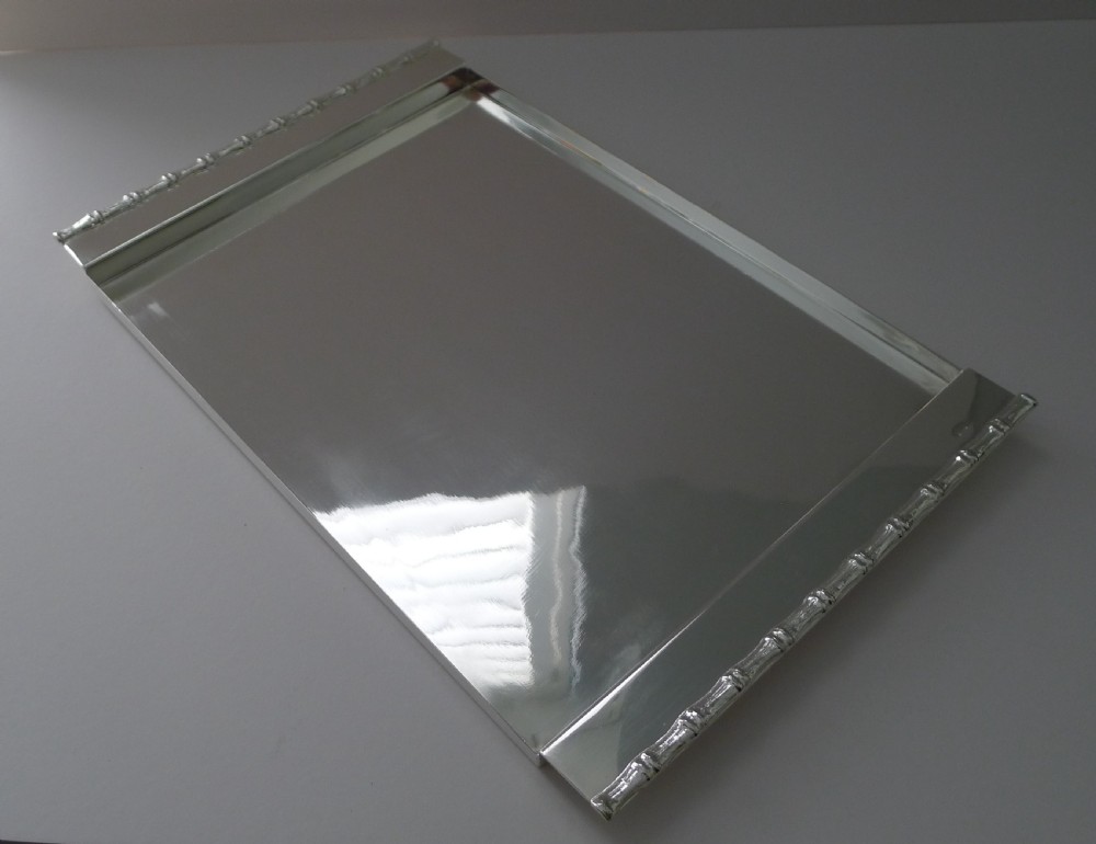 A rectangular polished silver-plated tray featuring cast bamboo-style handles along two opposite ends. View VII