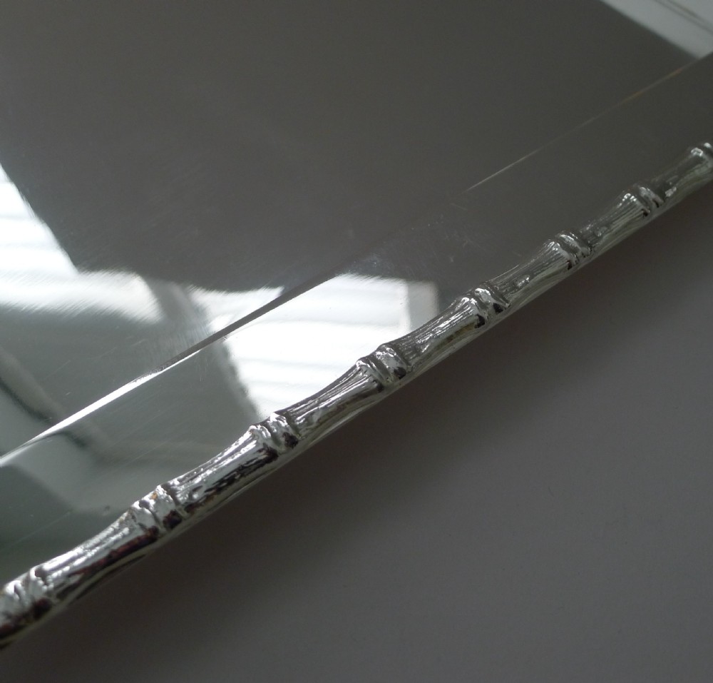 A rectangular polished silver-plated tray featuring cast bamboo-style handles along two opposite ends. View VIII