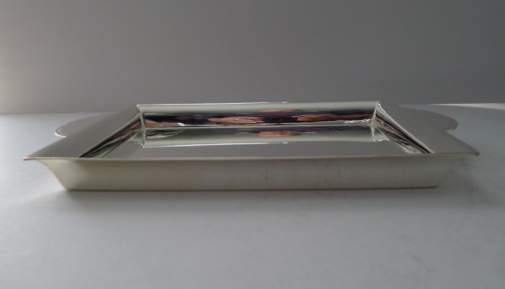 A polished rectangular silver-plated cocktail tray featuring a stepped moulded rim and integrated curved handles. View V