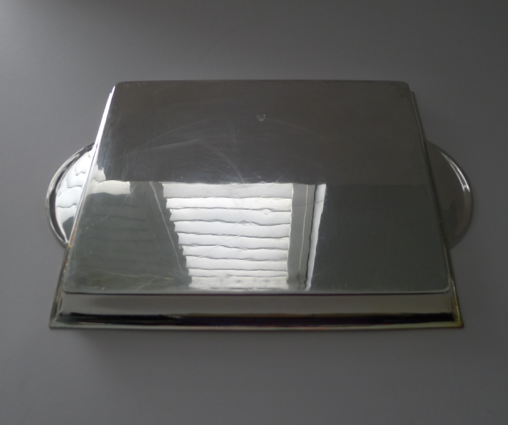 A polished rectangular silver-plated cocktail tray featuring a stepped moulded rim and integrated curved handles. View IX