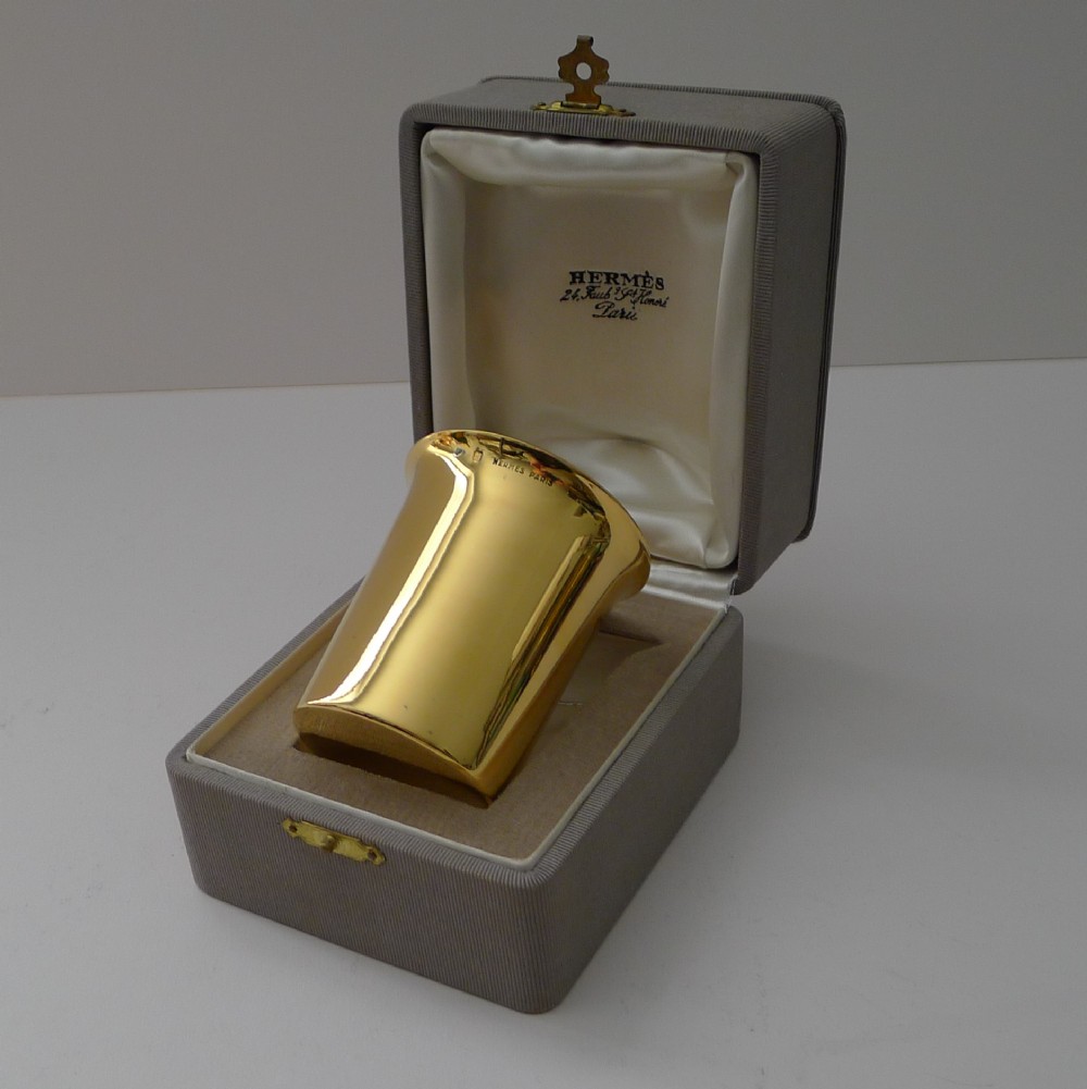 A mid-century French sterling silver-gilt beaker by Hermes Paris displayed inside its original fabric-lined grey presentation box.