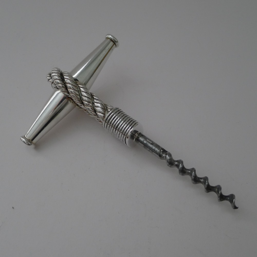 A mid-century silver Hermes T-bar corkscrew featuring a textured rope-twist handle and steel worm.