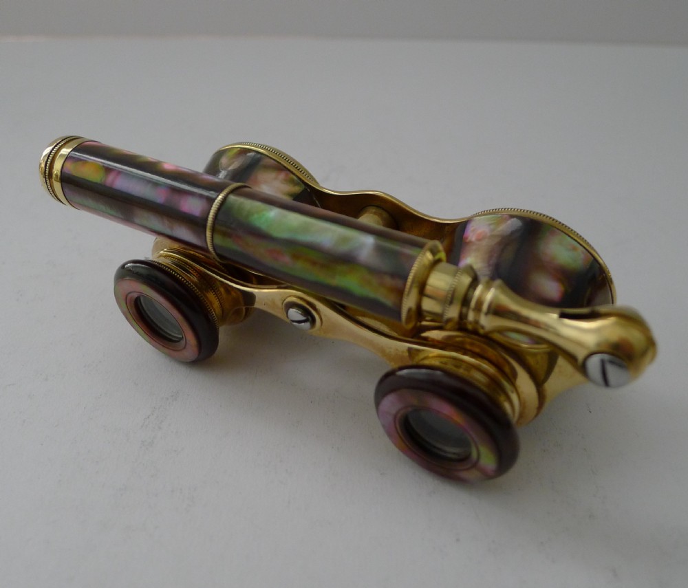 Antique French opera glasses with iridescent abalone shell panels, brass hardware, and a folding lorgnette handle. View II